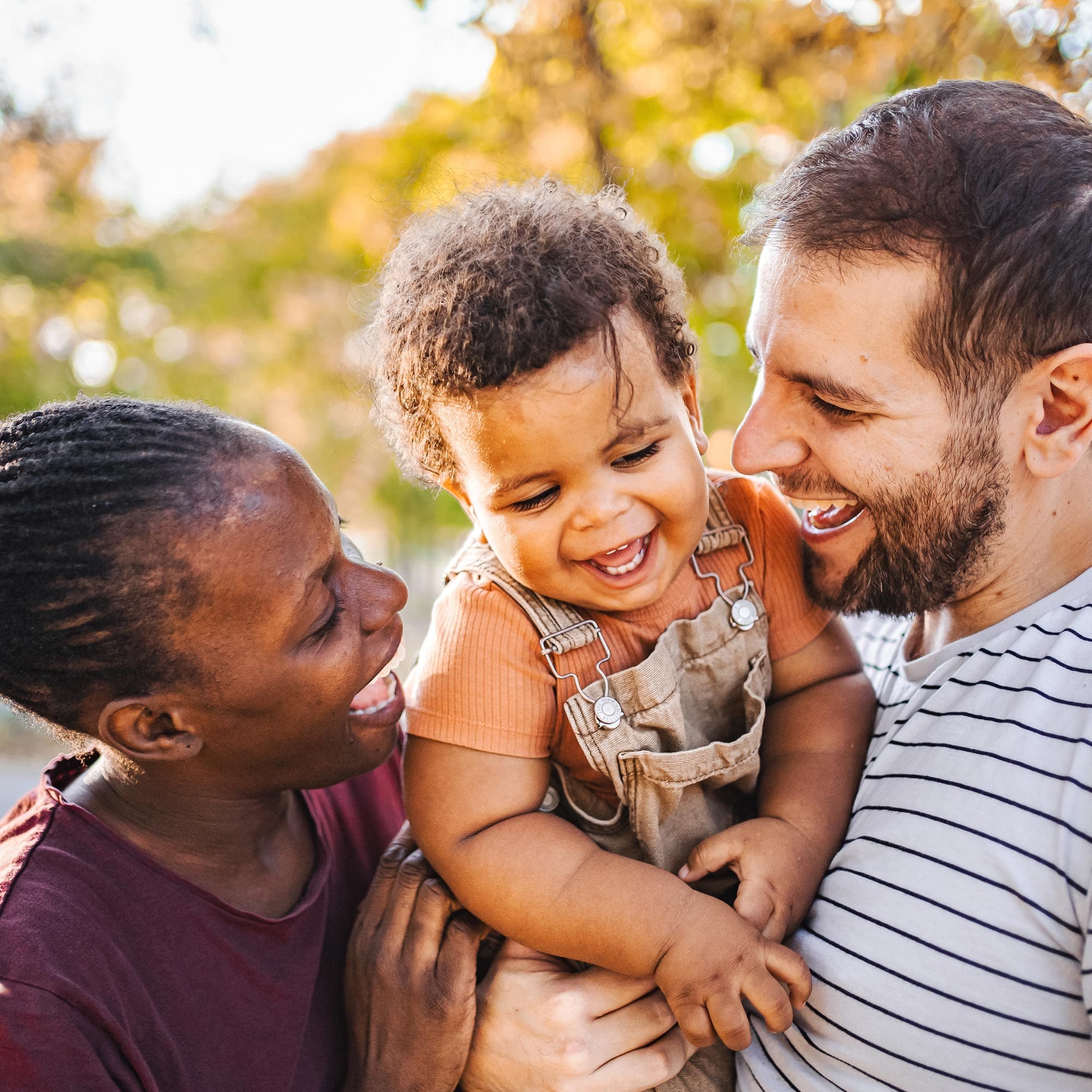 A bi-racial couple with their child.