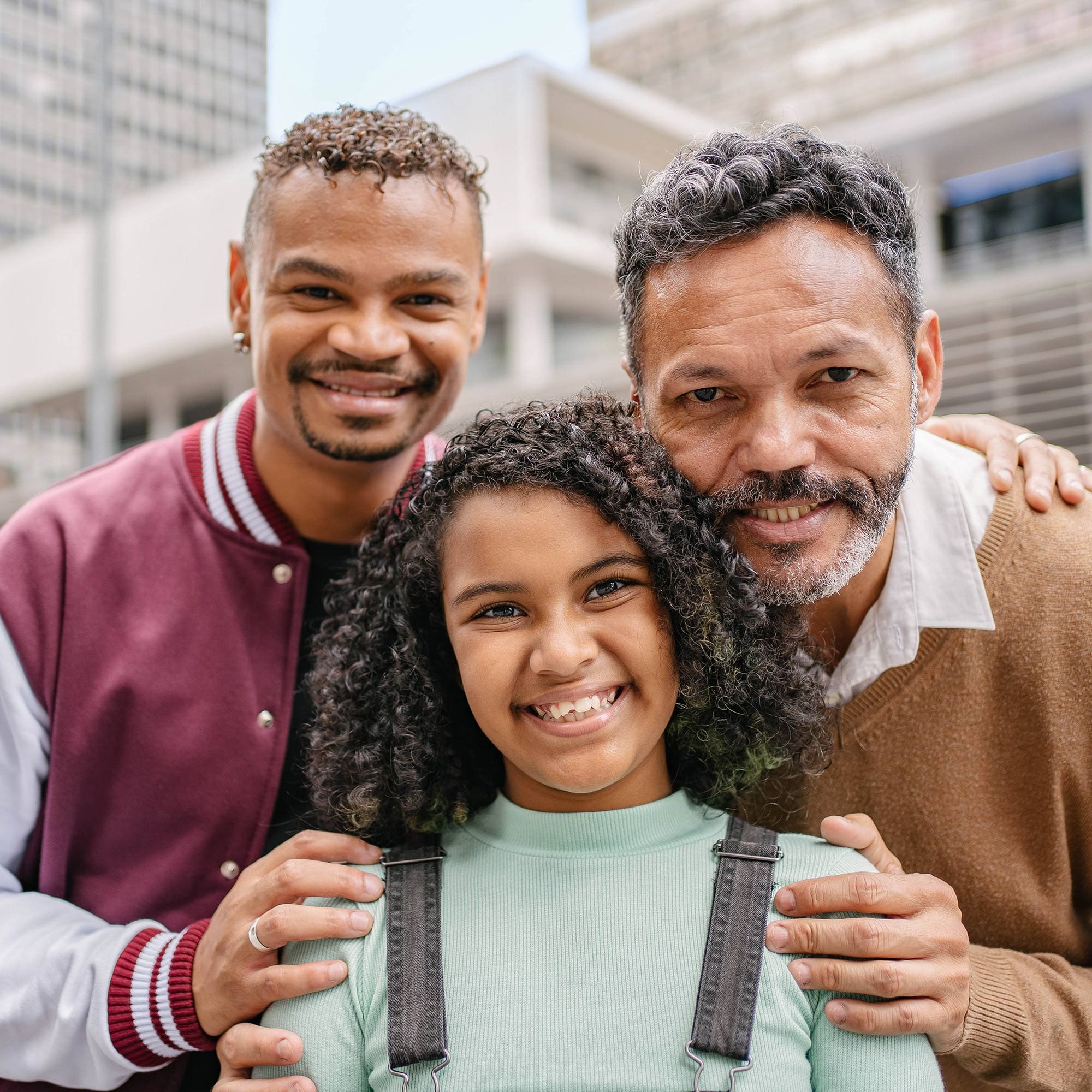 Two same-sex parents with their daughter.